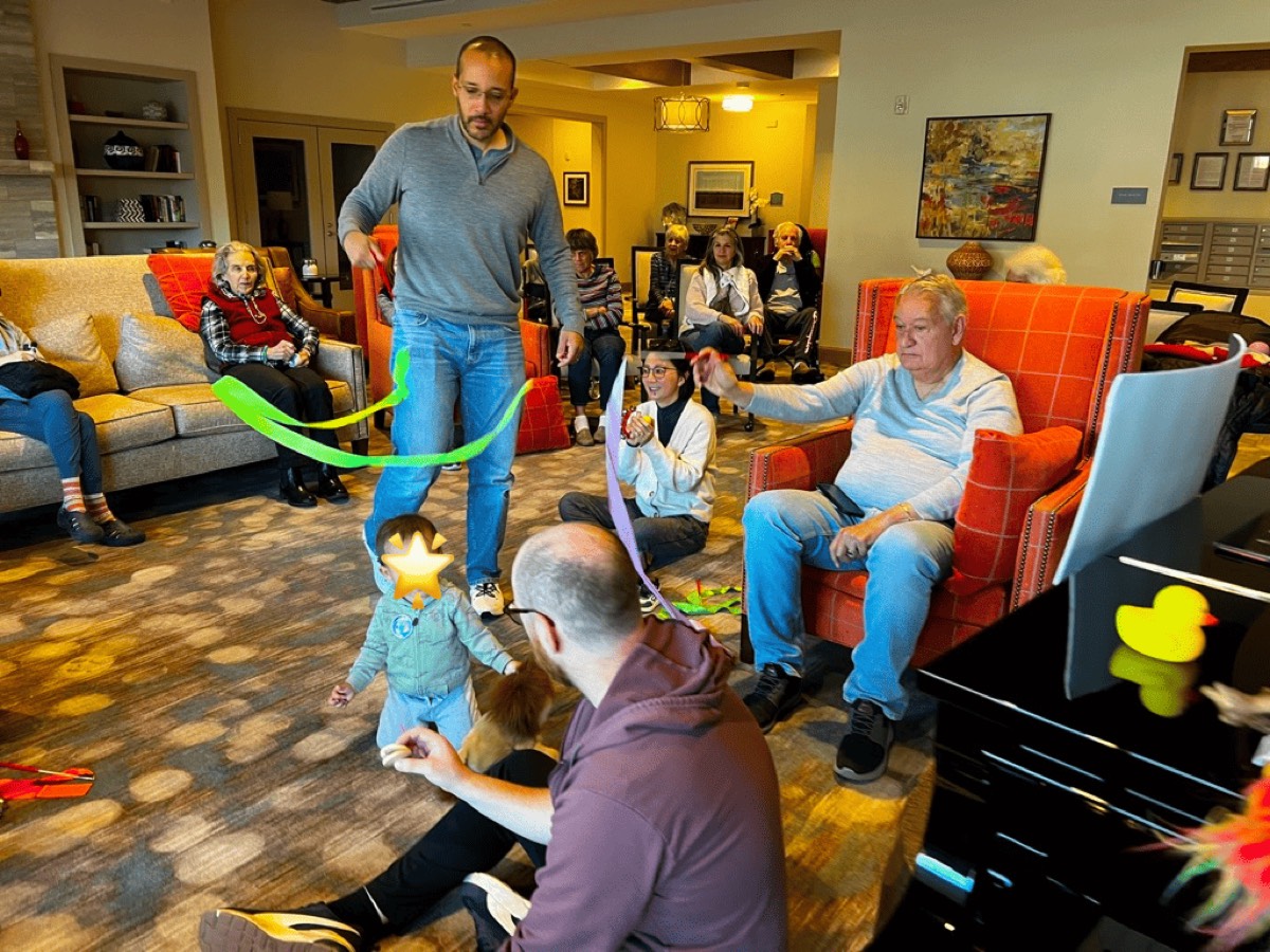 Toddlers and seniors making music together